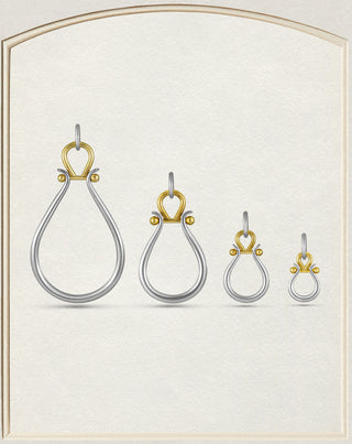 Four silver teardrop-shaped drop earrings with gold crown and bead accents, displayed in a graduated size lineup on a textured cream background.