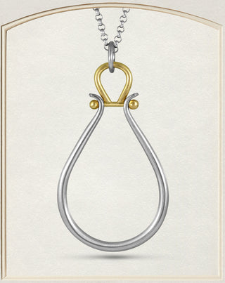 A two-tone silver and gold pendant necklace featuring a teardrop-shaped silver loop with a gold top loop and small gold beads, suspended from a silver chain against a cream-colored background.